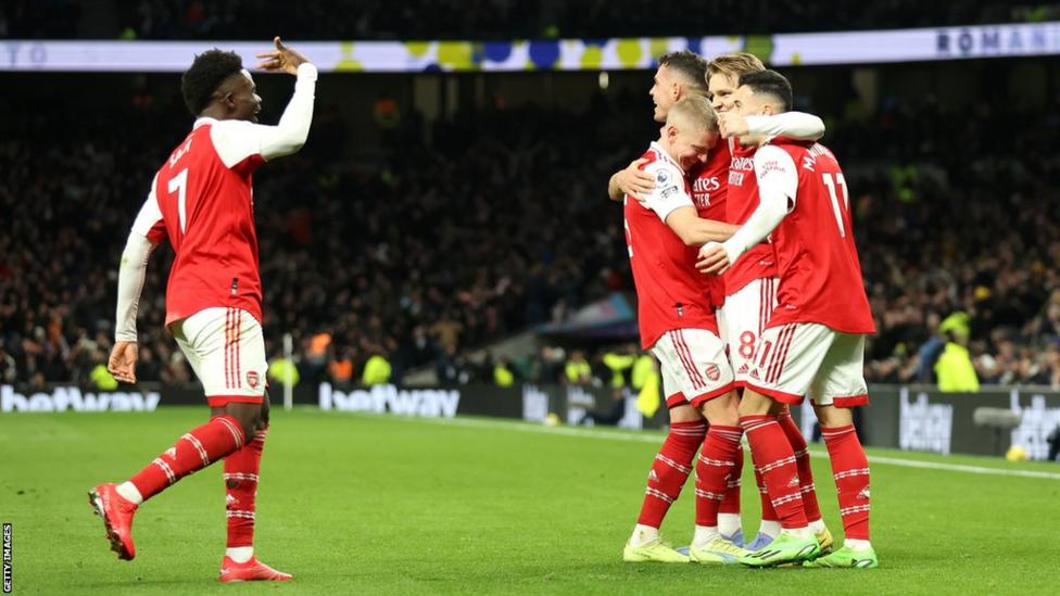 Arsenal celebrate after doubling their lead at Tottenham.